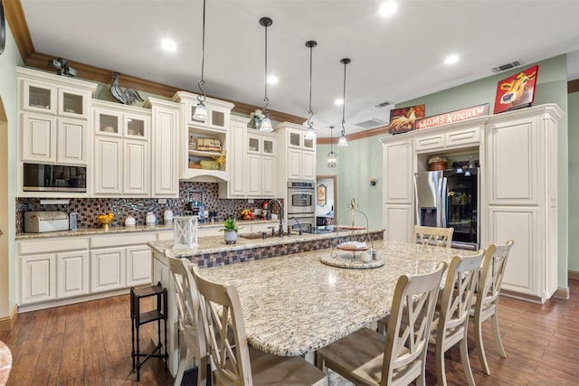 10790 White Settlement Rd, Fort Worth, TX 76108 - kitchen featuring appliances with stainless steel finishes, backsplash, a spacious island, a kitchen breakfast bar, and dark wood-style flooring