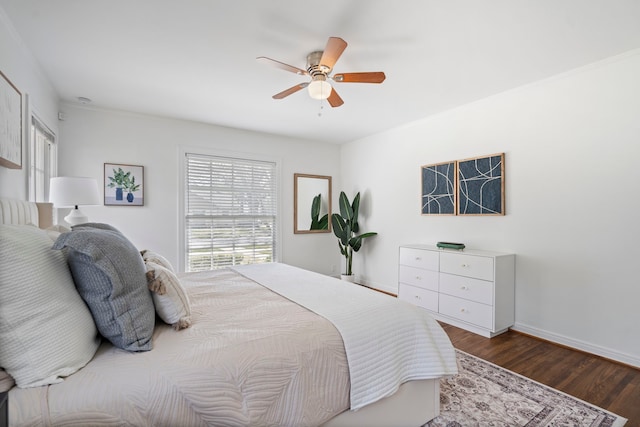 bedroom featuring a ceiling fan, dark wood-style floors, and baseboards
