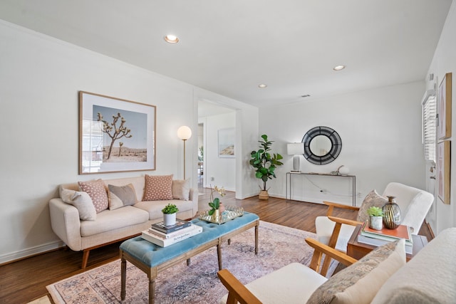 living area with recessed lighting, baseboards, and wood finished floors