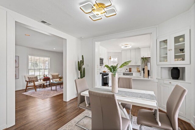 dining room featuring baseboards, visible vents, and dark wood-type flooring