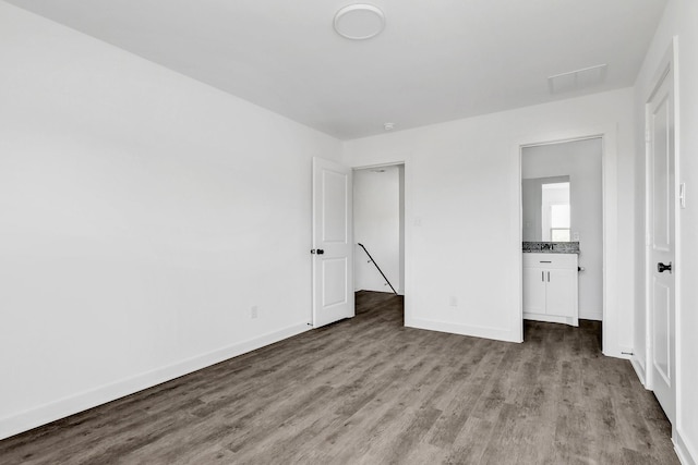 2616 S Fannin Ave, Denison, TX 75020 - unfurnished bedroom with visible vents, baseboards, and wood finished floors