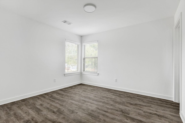 2616 S Fannin Ave, Denison, TX 75020 - unfurnished room featuring baseboards, dark wood-style floors, and visible vents