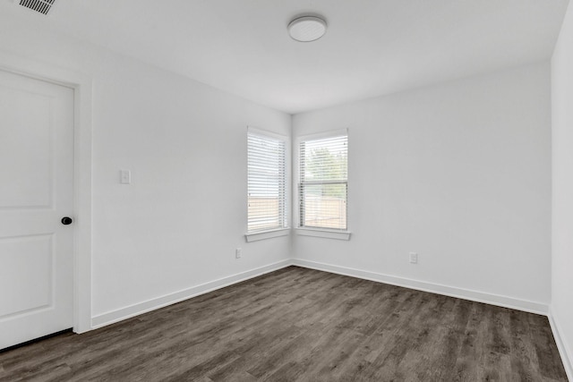 2616 S Fannin Ave, Denison, TX 75020 - spare room featuring dark wood-style floors, baseboards, and visible vents