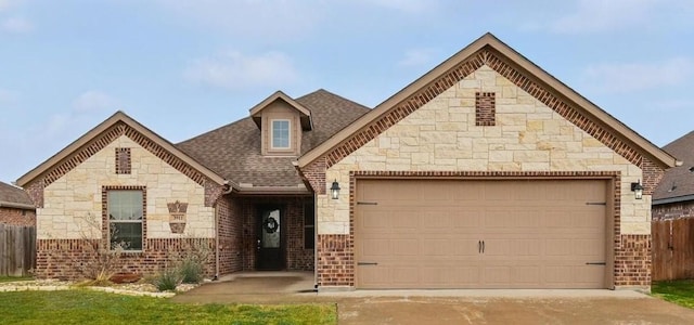 3911 Bridle Path Ln, Sanger, TX 76266 - french country inspired facade with stone siding, an attached garage, a shingled roof, driveway, and brick siding