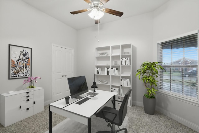 3911 Bridle Path Ln, Sanger, TX 76266 - office area featuring baseboards, a ceiling fan, and dark aggregate flooring