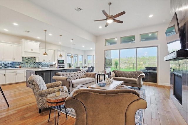 2193 Cloverfern Way, Haslet, TX 76052 - living area with ceiling fan, visible vents, a tile fireplace, and light wood finished floors