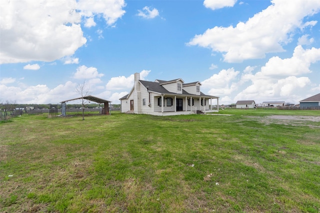 exterior space featuring a chimney, a carport, and a yard