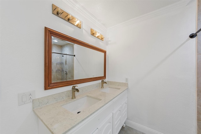 bathroom featuring double vanity, a sink, tiled shower, and crown molding