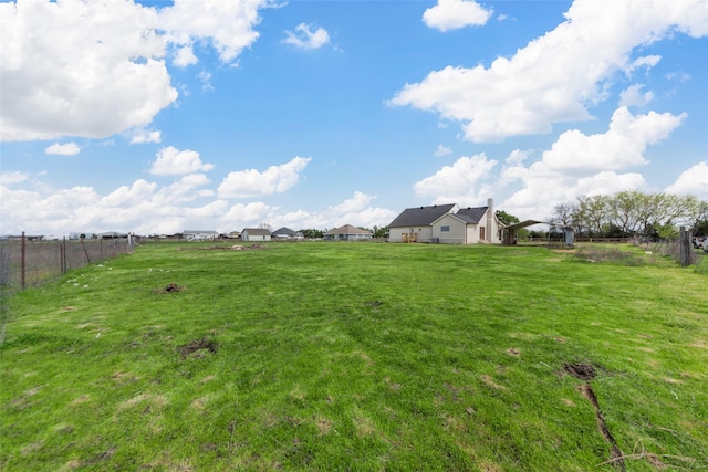 view of yard featuring fence and a rural view