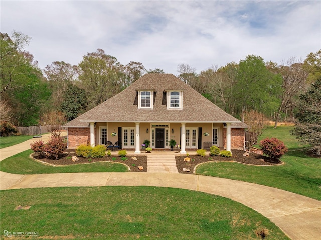 521 Lovers Lndg, Bossier City, LA 71111 - view of front facade featuring a shingled roof, brick siding, a front yard, and french doors