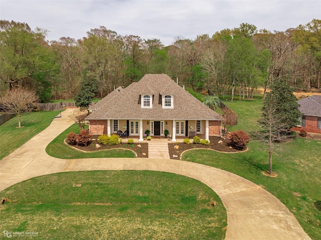521 Lovers Lndg, Bossier City, LA 71111 - view of front facade featuring covered porch, french doors, curved driveway, a front lawn, and a shingled roof