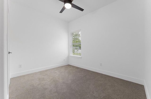318 Whitworth St, Sulphur Springs, TX 75482 - unfurnished room with baseboards, dark carpet, and a ceiling fan