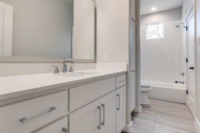 bathroom featuring toilet, tile patterned flooring, vanity, and bathing tub / shower combination