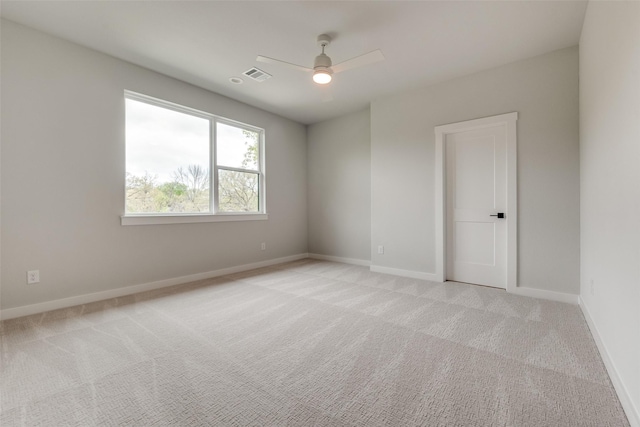 unfurnished room with light carpet, baseboards, ceiling fan, and visible vents