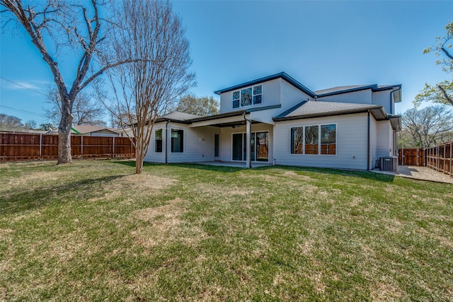 rear view of house with a patio area, cooling unit, a yard, and a fenced backyard