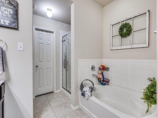 7913 Wildwest Dr, Fort Worth, TX 76131 - full bathroom featuring a garden tub, tile patterned flooring, a stall shower, vanity, and baseboards