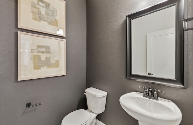 2621 Landmark Dr, Celina, TX 75009 - half bathroom with toilet, a sink, and a textured wall
