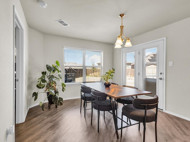 6348 Sloop St, Fort Worth, TX 76179 - dining room with wood finished floors, baseboards, and visible vents