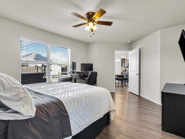 6348 Sloop St, Fort Worth, TX 76179 - bedroom featuring baseboards, wood finished floors, and a ceiling fan
