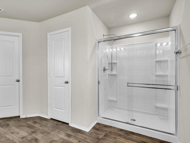 6348 Sloop St, Fort Worth, TX 76179 - full bathroom featuring visible vents, a stall shower, baseboards, and wood finished floors
