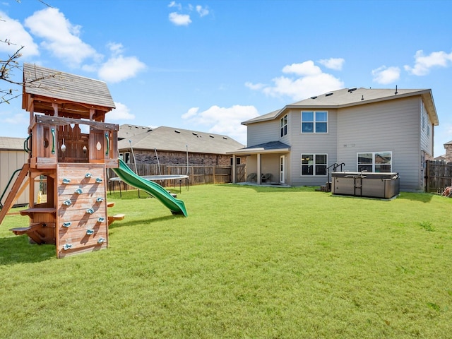 6348 Sloop St, Fort Worth, TX 76179 - back of property with fence, a trampoline, a playground, and a yard