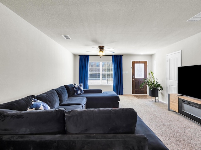 6348 Sloop St, Fort Worth, TX 76179 - living area with light carpet, a textured ceiling, ceiling fan, and visible vents
