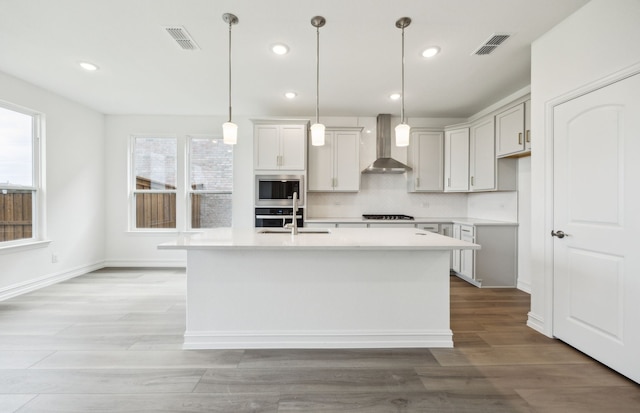 244 Kistler Dr, Little Elm, TX 76227 - kitchen featuring wall chimney exhaust hood, plenty of natural light, tasteful backsplash, an island with sink, and recessed lighting