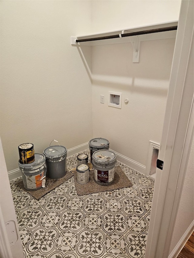 clothes washing area featuring tile patterned flooring, hookup for a washing machine, baseboards, and laundry area
