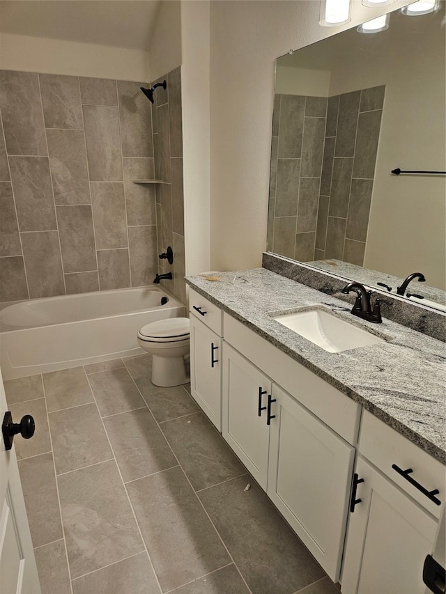 bathroom featuring toilet, vanity, shower / tub combination, and tile patterned flooring