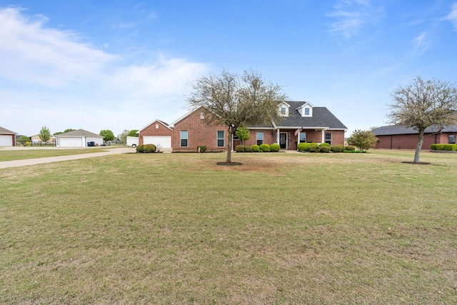 view of front facade with brick siding, a front yard, and concrete driveway