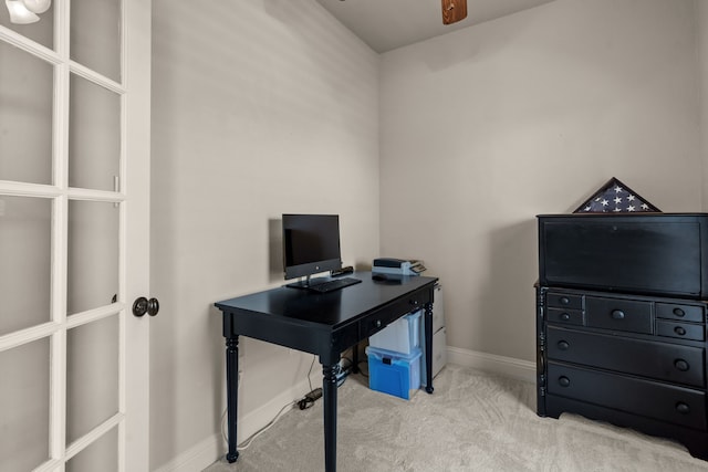 carpeted home office featuring baseboards and a ceiling fan