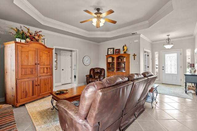 living area featuring a raised ceiling, visible vents, light tile patterned floors, and ceiling fan