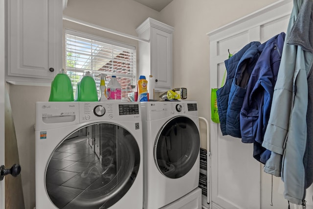 laundry room with washer and clothes dryer and cabinet space