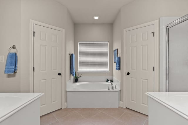 bathroom featuring a bath, tile patterned floors, vanity, and a stall shower