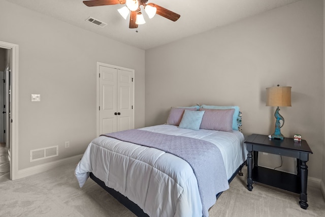 carpeted bedroom with a closet, baseboards, and visible vents