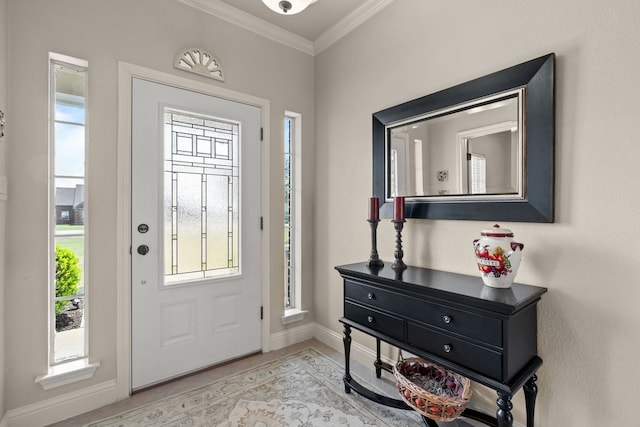 foyer with crown molding and baseboards