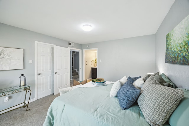 carpeted bedroom featuring baseboards and visible vents