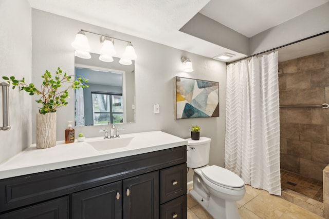 full bathroom featuring a tile shower, toilet, tile patterned flooring, and vanity