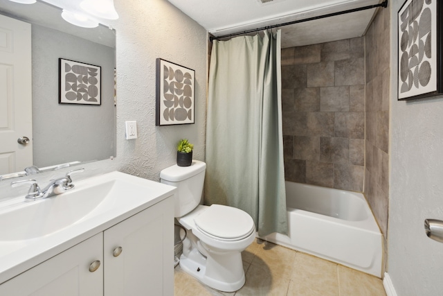 bathroom featuring vanity, toilet, a textured wall, tile patterned floors, and shower / bath combination with curtain