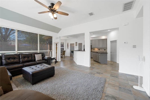 1808 Paddington Ct, Arlington, TX 76017 - living room featuring stone tile floors, ceiling fan, and baseboards