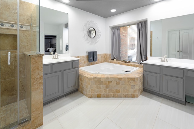 1808 Paddington Ct, Arlington, TX 76017 - bathroom with a shower stall, a garden tub, tile patterned floors, two vanities, and recessed lighting