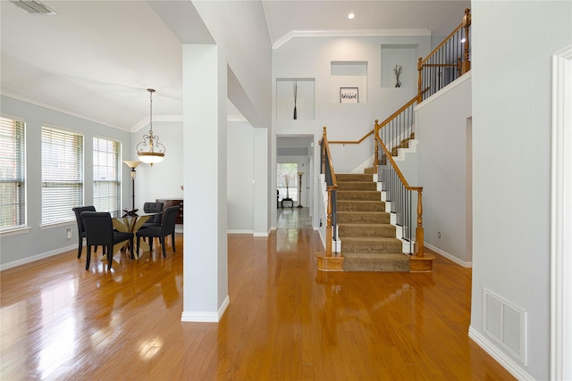 1808 Paddington Ct, Arlington, TX 76017 - foyer entrance with wood finished floors, stairway, baseboards, a chandelier, and ornamental molding