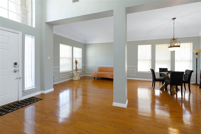 1808 Paddington Ct, Arlington, TX 76017 - foyer featuring crown molding, wood finished floors, baseboards, and a wainscoted wall