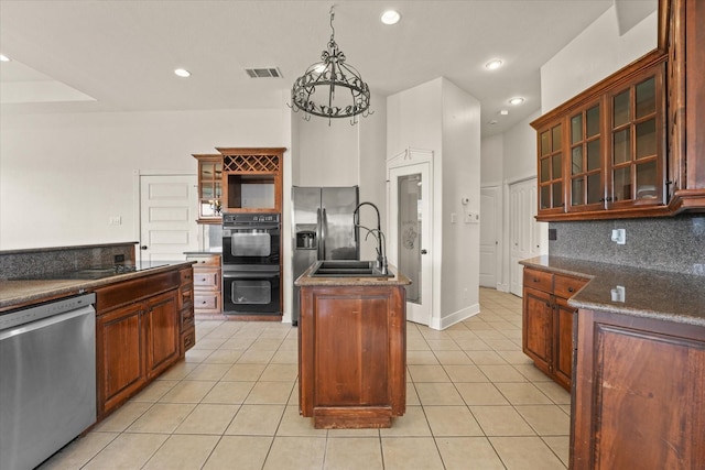 153 Whispering Winds Dr, Gunter, TX 75058 - kitchen featuring black appliances, an island with sink, light tile patterned flooring, decorative backsplash, and recessed lighting