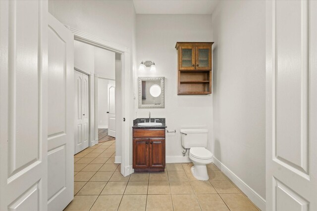 153 Whispering Winds Dr, Gunter, TX 75058 - half bath featuring tile patterned flooring, toilet, vanity, and baseboards