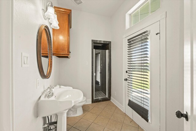 153 Whispering Winds Dr, Gunter, TX 75058 - bathroom featuring tile patterned flooring, a stall shower, baseboards, and toilet