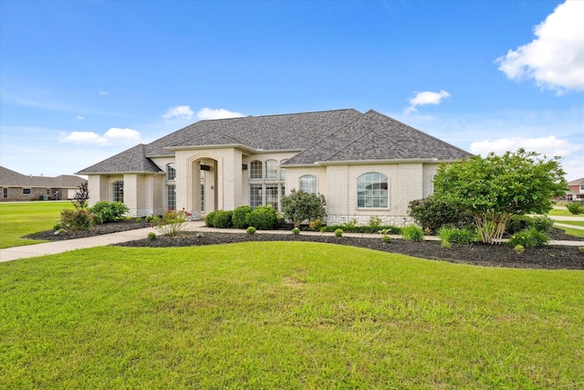 153 Whispering Winds Dr, Gunter, TX 75058 - french provincial home featuring brick siding, a front yard, and roof with shingles