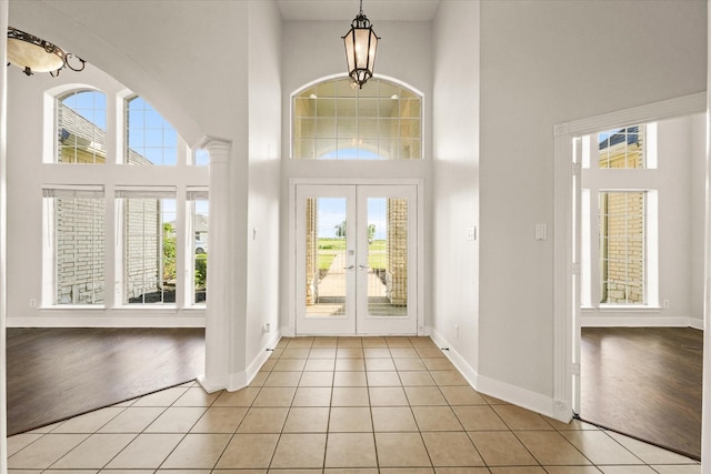 153 Whispering Winds Dr, Gunter, TX 75058 - foyer entrance with a towering ceiling, healthy amount of natural light, french doors, and light tile patterned floors