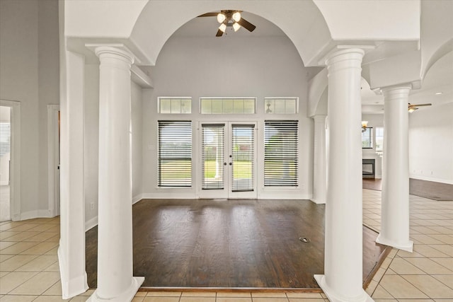 153 Whispering Winds Dr, Gunter, TX 75058 - foyer featuring a ceiling fan, ornate columns, french doors, tile patterned floors, and a towering ceiling