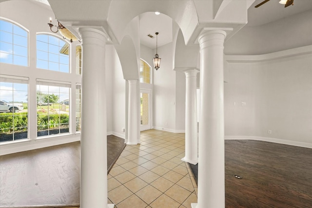 153 Whispering Winds Dr, Gunter, TX 75058 - foyer entrance featuring ornate columns, plenty of natural light, light tile patterned floors, and a high ceiling